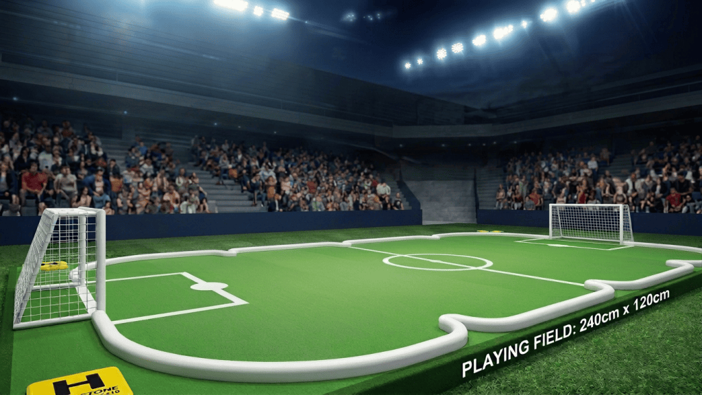 Four racing drones in blue, red, and yellow playing soccer on a mini soccer field controlled by two players with VR headsets